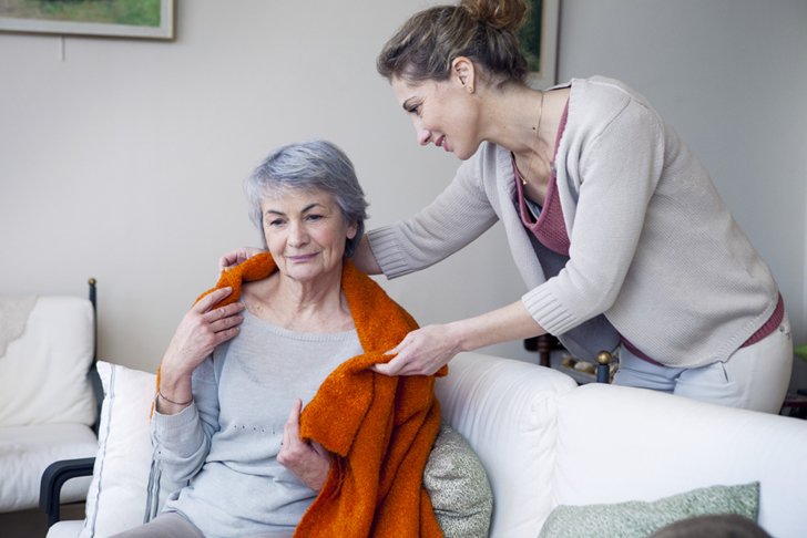 Caregiver providing compassionate care to senior resident